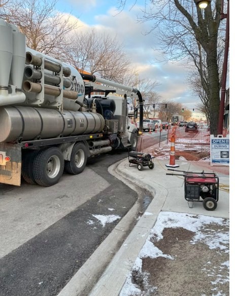 Vacuum truck working a downtown storm sewer